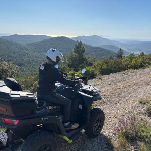 Quad rider at a viewpoint overlooking the sea on Korčula