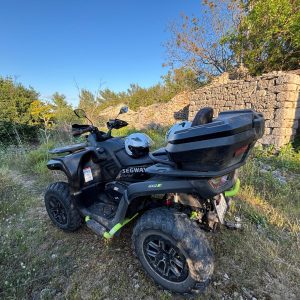 Quad bikes passing old stone ruins on a Korčula island trail